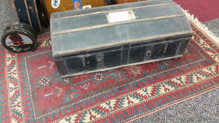there's that travel trunk!  nail head decor - great condition....sitting on a nice area rug too!