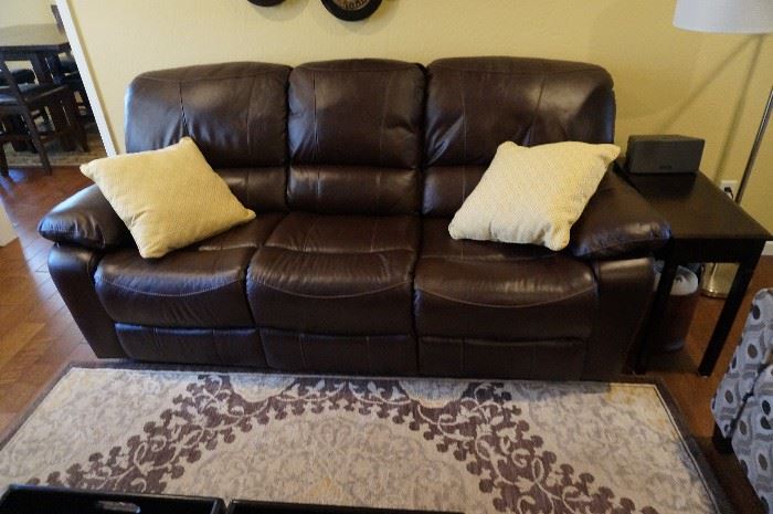 Leather, double reclining sofa with console between the two recliners which has the cup holders and usb plug-ins