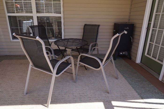 Outdoor furniture ~ table, 4 chairs, 2 end tables and an area rug