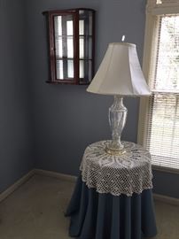 Circular table, hanging curio cabinet and glass lamp