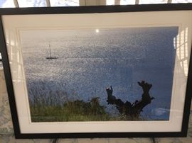 Large framed photograph depicting a boat, sails furled