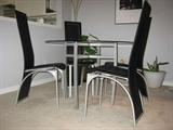 BOVA 42" Glass Top & Brushed Steel Dining Table with Black Leather & Brushed Steel Chairs