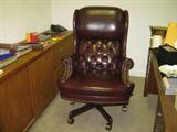 Executive high back desk chair -- on casters, covered in burgundy leatherette