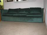 Mid century green corduroy upholstered sofa with loose seat and back cushions, ends have parquet wood and steel band finish