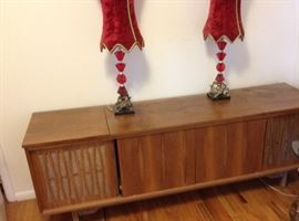 Midcentury console with turntable and stereo receiver. 

Pair of red velvet lamps.
