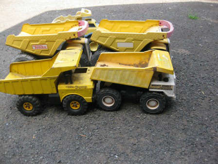 Tonka trucks, some metal, some plastic