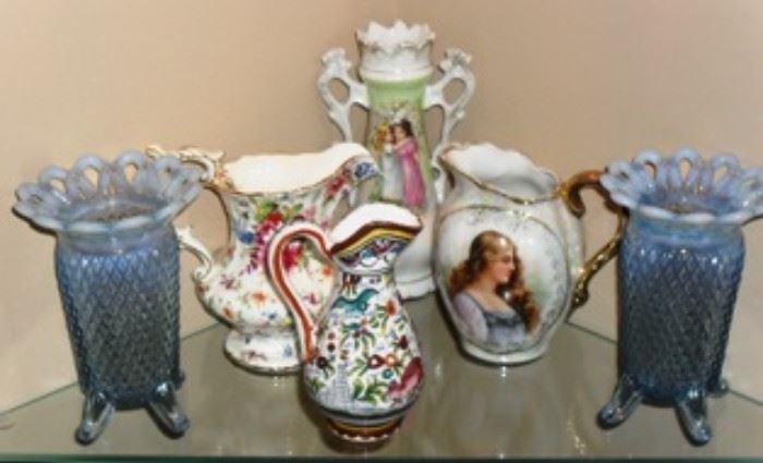 Fenton Vases, Austria Victoria pitcher,  and other small pitchers in curio cabinet