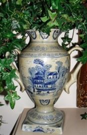 One of a pair of mantel urns with greenery