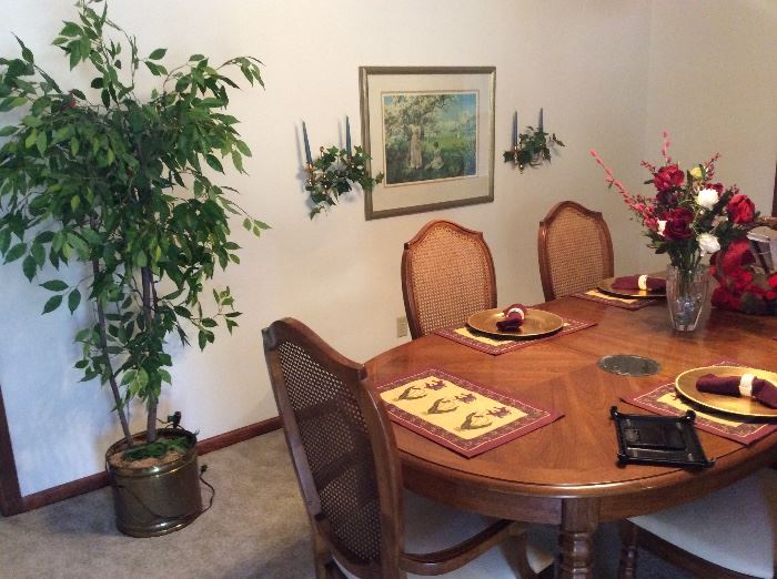 Beautiful Thomasville dining table with 6 matching chairs, pads, and 2 leaves.  artificial plant, wall decor and picture. 