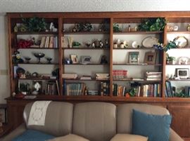 Lovely leather sofa and collectibles on shelf unit in background. 