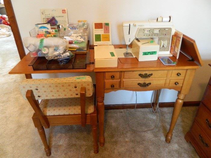 Singer Sewing machine with cabinet, accessories & monogrammer. Matching chair for sewing machine