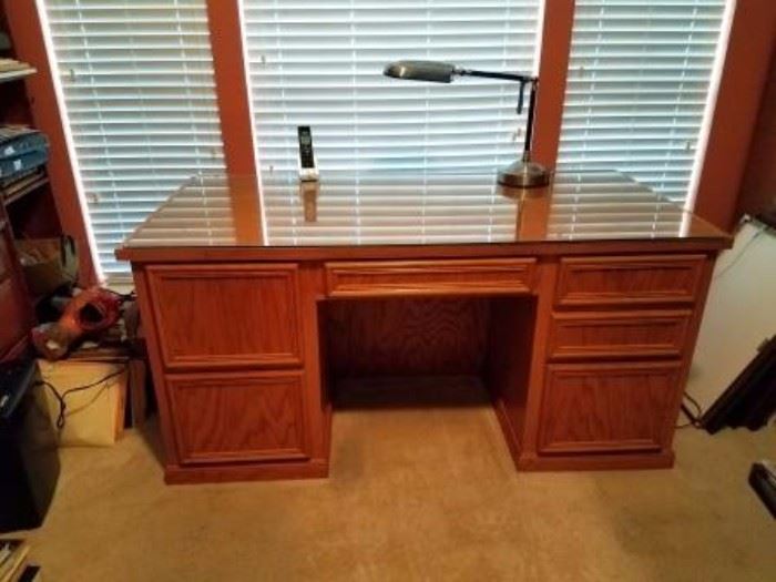 Double pedestal solid oak desk with glass top.