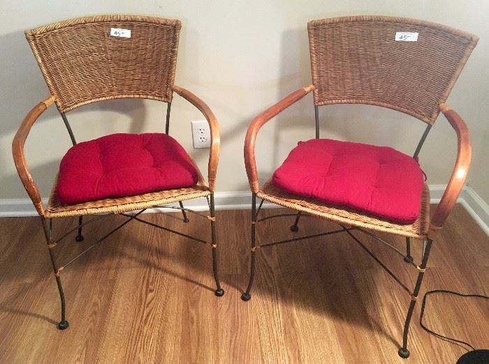 Pair of natural fiber chairs with red cushions