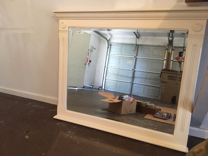 White framed mirror with white washed wooden trim