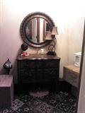 Wood entry chest with round matching mirror, lamp, candles.