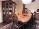 Large formal wooden dining table, extra leaves, 6 chairs, china cabinet with dishes, crystal glasses.