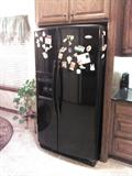 Less than 5 years old, black, side/side refrigerator with ice/water in door.