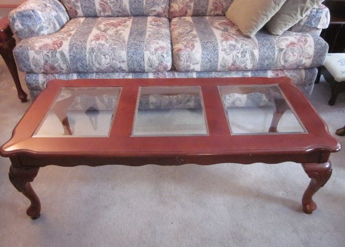 Wood coffee table with beveled glass inserts.  49-1/2" long, 24" wide, 15" tall