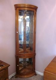 Corner curio cabinet, solid oak, two doors, round glass, glass shelves, mirrored back, lighted.  75-1/2" tall, 22" wide, 16" deep