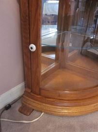 Corner curio cabinet, solid oak, two doors, round glass, glass shelves, mirrored back, lighted.  75-1/2" tall, 22" wide, 16" deep