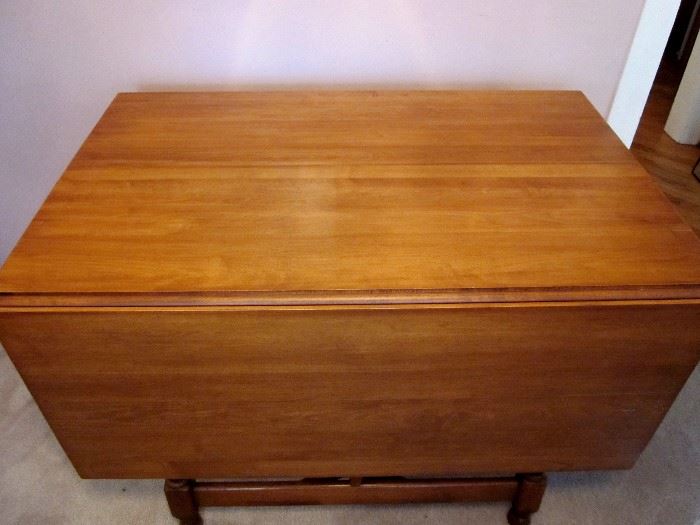 Solid maple double drop-leaf table with three leaves.  Expands to a maximum length of 67".  Extremely well made.  Four solid maple chairs (one needs repair).