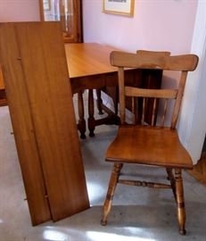 Solid maple double drop-leaf table with three leaves.  Expands to a maximum length of 67".  Extremely well made.  Four solid maple chairs (one needs repair).