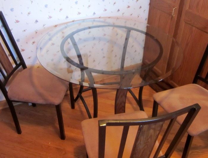 Round beveled glass top (42")  dinette set, black aluminum frame with four matching chairs.