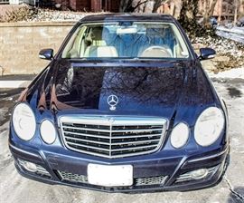 2008 Mercedes-Benz E350 Luxury Sedan: A 2008 Mercedes-Benz E350 4MATIC 4-door luxury sedan in Capri Blue. This E-Class vehicle features a 3.5 liter V6 engine, 5-speed shiftable automatic transmission, all-wheel drive, and anti-lock brakes. The interior is trimmed in wood grain with tan leather steering wheel and seats; it includes front, rear, and side airbags; heated seats; a CD player and radio with LCD display; cruise control; and more. The vehicle had a mileage of 115,717 at the time of cataloging; VIN is WDBUF87X88B253180.