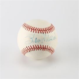 Stan Musial Signed Baseball: A baseball signed by Stan Musial. This Rawlings Official League baseball is signed in blue ink on the “sweet spot” by Musial. Stan Musial played twenty-two seasons with the St. Louis Cardinals before being inducted into the Baseball Hall of Fame in 1969.