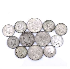 Four Peace Silver Dollars and Eight Silver Kennedy Half Dollars: A group of four Peace silver dollars and eight silver Kennedy half dollars. Peace dollar dates include 1922 S, 1923 D, 1923 S and 1923 S. Two of the Kennedy half dollars are from 1964 and the others are silver clad from the late sixties. Metal Content of Peace dollars and 1964 half dollars: 90% silver, 10% copper. Peace dollar diameter: 38.1 mm. Peace dollar weight: 26.73 grams (each). Kennedy half dollar diameter: 31 mm. Kennedy half dollar weight: 12.5 grams (each). Circulated. Good condition.
