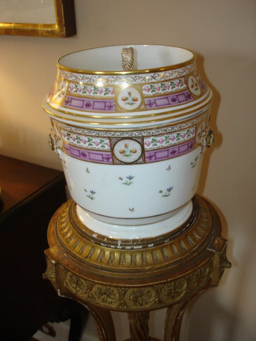 Early 19th century porcelain fruit cooler with liner on one of two antique gilded French pedestals.