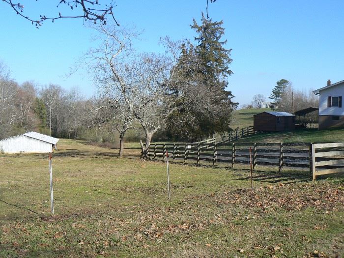 Road Frontage on a beautiful fenced 5 acres, small outbuilding, carport, and tractor behind house go with house and are NOT FOR SALE SEPARATELY.  Huge Potential for rental property available.  Water source on property and barn for livestock.   