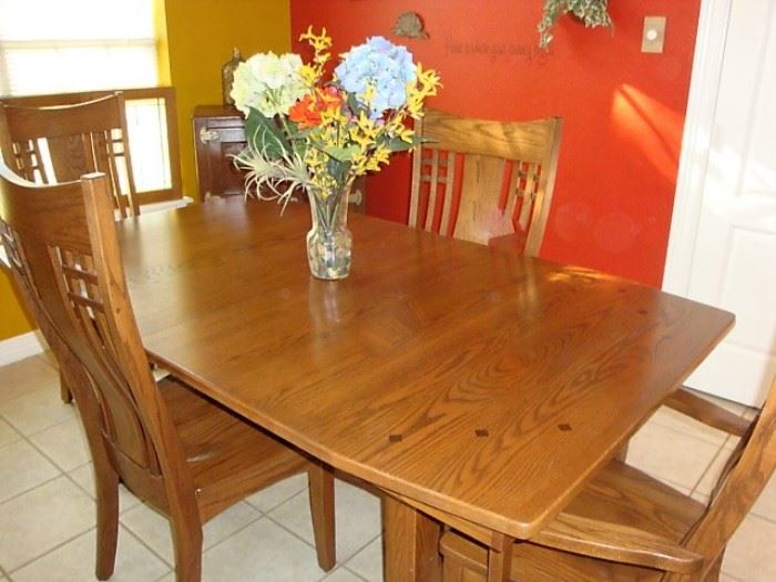 SHAKER HILL TRESTLE TABLE & (6) MISSION CHAIRS. EXTRA LEAVES ARE STORED WITHIN THE TABLE. THIS IS A PHENOMENAL SET OF AMISH CRAFTED FURNITURE! TRUST ME WHEN I TELL YOU THAT THE PICTURE DOES NOT DO JUSTICE TO THIS FINE PIECE OF FURNITURE.