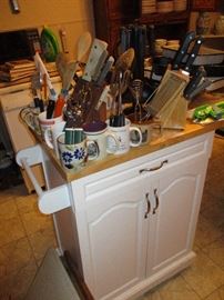 Rolling island filled with utensils