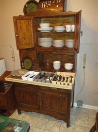 Hoosier cabinet, filled with everyday dishes and flatware