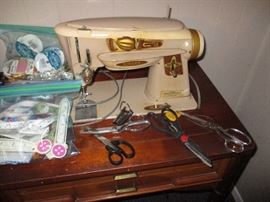 Vintage Singer sewing machine with cabinet.