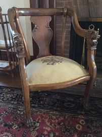 WOW. Stately lion head chairs - there is one 4 leg chair and one rocker