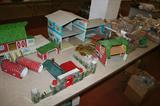 Tin playset pieces including Marx barns, doll house, Bar M Ranch building, knight's castle tin pieces,