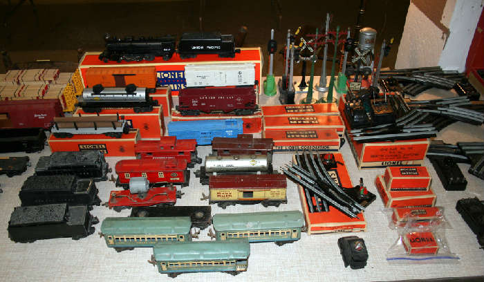 Boxed post war Lionel cars & misc cars incl. 3 car tin litho Lionel passenger set. Early tinplate Lionel cars. 1990's Lionel steam engine, tender in box. 3 Lionel 2466wx whistle tenders. Lionel signals and lights and crossings.