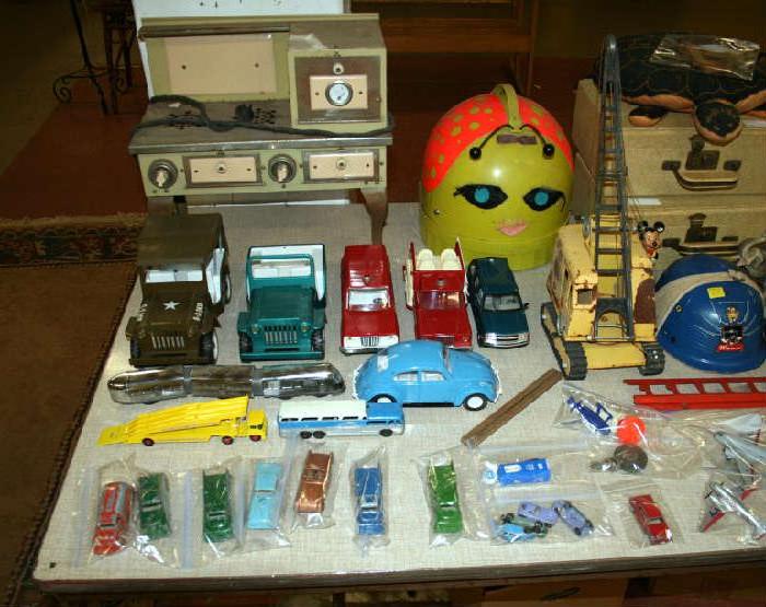 1960's Beautybug hair dryer...it's that green and orange thing. 1930's child's electric stove on legs. Tonka jeeps, VW, crane and early Soap Box Derby helmet.
