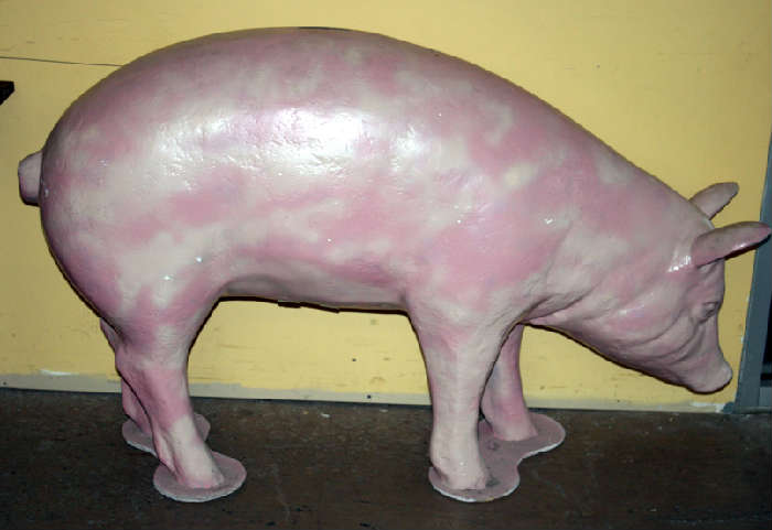 Lifesize pig made into piggy bank with trap door bottom. Needs a new paint job or time in the tanning/smoking beds.