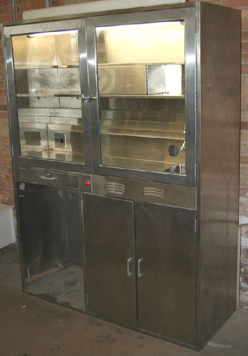 Industrial modern stainless steel lighted pharmacy cabinet. Came out of ICC nursing school. Has space on bottom left for small refridgerator....standard mini fridge fits in there perfect. Has sink and lockable storage above and storage below. Has tiered storage area inside. Would make great bar in loft or office. Measures 23" deep x 5' wide and 80" tall.