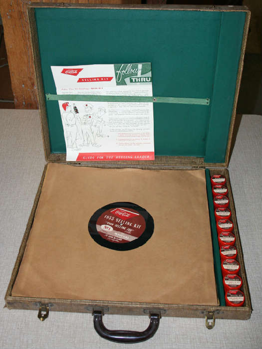Really cool 1955 Coca Cola Salesman's Selling Kit from Peoria Coca Cola Bottling Plant on Adams Street. Includes a bunch of giant records by the Jim Handy Company filled with inspirational selling tips and the best part....a bunch of vintage film strips with great images from 1955 showing the retailer how to best market Coca Cola products. Nice original condition.