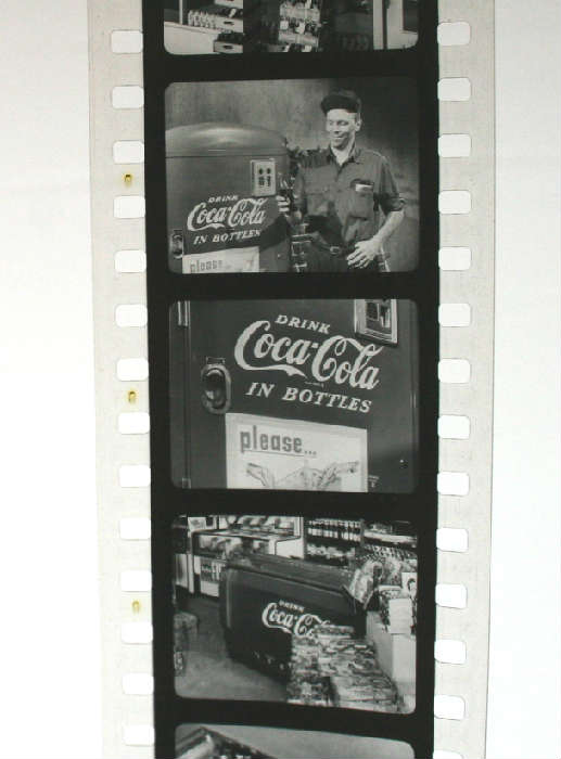 Really cool 1955 Coca Cola Salesman's Selling Kit from Peoria Coca Cola Bottling Plant on Adams Street. Includes a bunch of giant records by the Jim Handy Company filled with inspirational selling tips and the best part....a bunch of vintage film strips with great images from 1955 showing the retailer how to best market Coca Cola products. Nice original condition. This is from the Filmstrip about display.
