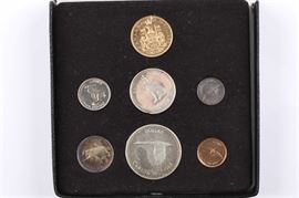 1967 Royal Canadian Seven Coin Mint Set with $20 Gold Coin: An 1867-1967 Royal Canadian seven coin Mint Set with $20 half-ounce gold coin. Includes the coat of arms $20 gold coin, flying goose silver dollar, howling wolf silver half dollar, running bobcat silver quarter, swimming mackerel silver dime, racing rabbit nickel, and soaring dove penny. Contains .5288 troy ounces of gold and 1.11 troy ounces of silver. Presented in the original mint box which is approximately 5 3/4" square. Good condition. A few of the coins are tarnished.