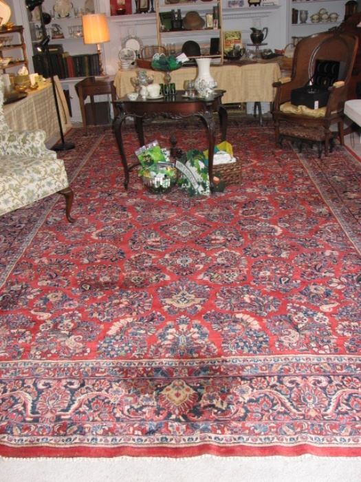 huge living room with a 10' x 17 Persian Sarouk rug centerpiece