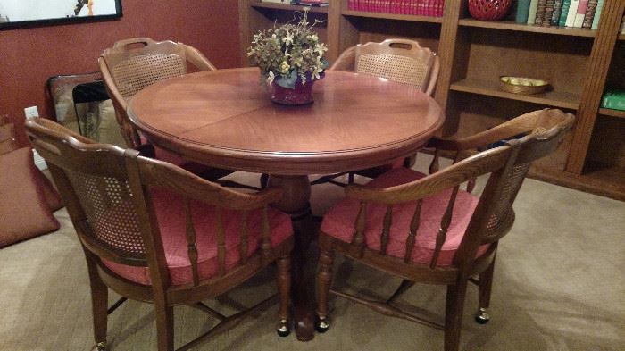 This is a unique pedestal Table. It has a very large leaf that makes it an oval table. The pedestal stays at one end when the leaf is inserted and there are 2 screw on support legs. There are 4 very comfortable chairs on rollers