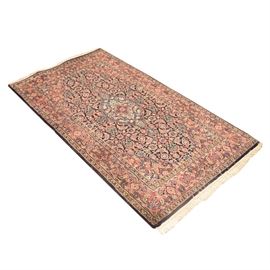 Handwoven Persian Accent Rug: A handwoven Persian accent rug. This rug features a central herati motif that utilizes a palette of blues, reds, creams, and greens. This rug also features a single border that utilizes the same palette as the central pattern. This rug has natural warp fringe to either end. It is unmarked on the reverse.