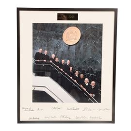 Signed Photograph of New York Supreme Court, Appellate Division Judges: A signed photograph of New York Supreme Court, Appellate Division judges. The photograph was taken in April of 2009, and has a plaque marking it as such at the top. The bottom of the matting is signed by all eleven appellate justices, in the order in which they are arraigned in the photograph. The photograph is matted and housed in a metal frame under glass.