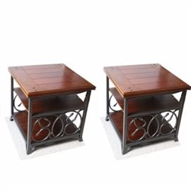 Contemporary Wood and Metal End Table Set: A pair of contemporary wood and metal end tables. Each table features a wood top and 2 wooden shelves flanked by a grey metal frame with decorative scrolls on either side.